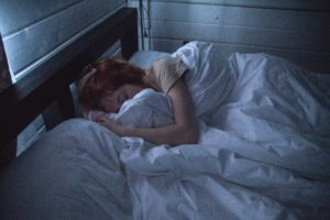Person trying to sleep - treating the root of insomnia.