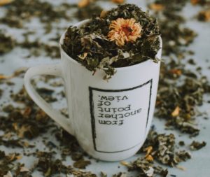 Mug with dried herbs - how to make an herbal tincture.