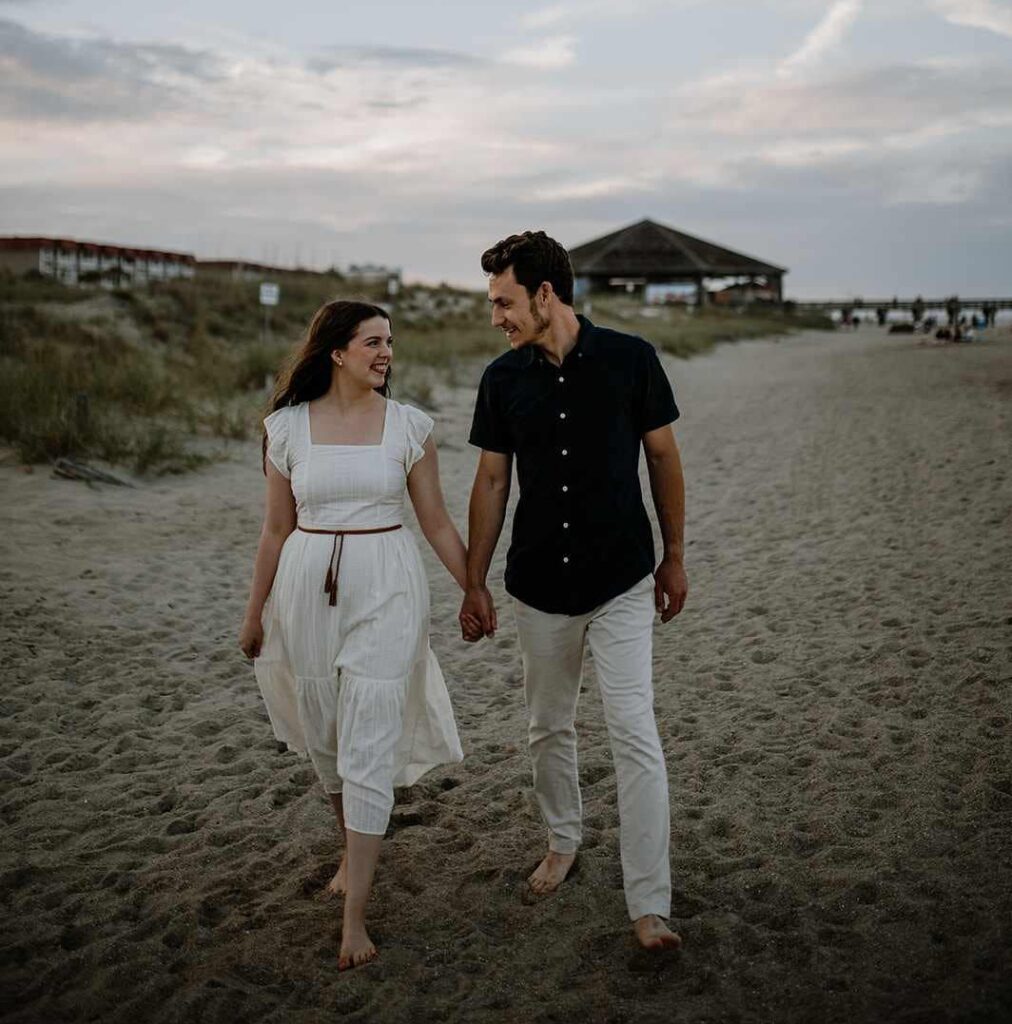 Hannah and Jonathan walking along the beach, holding hands. Big change is happening - a health and adoption process update.