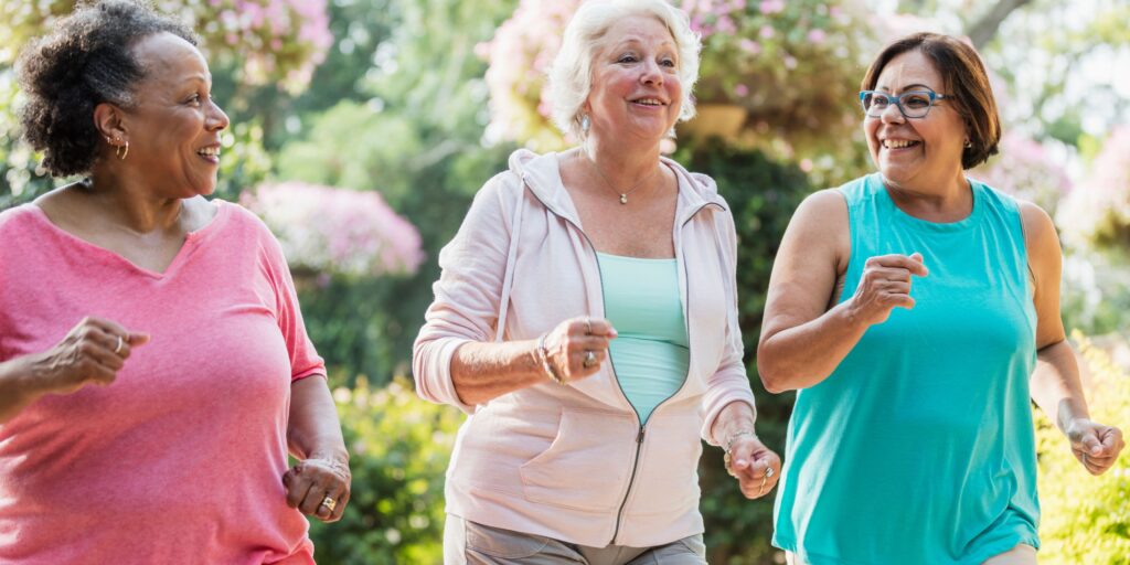 Three older women enjoying a jog outside together. How to understand weight gain from a holistic perspective.